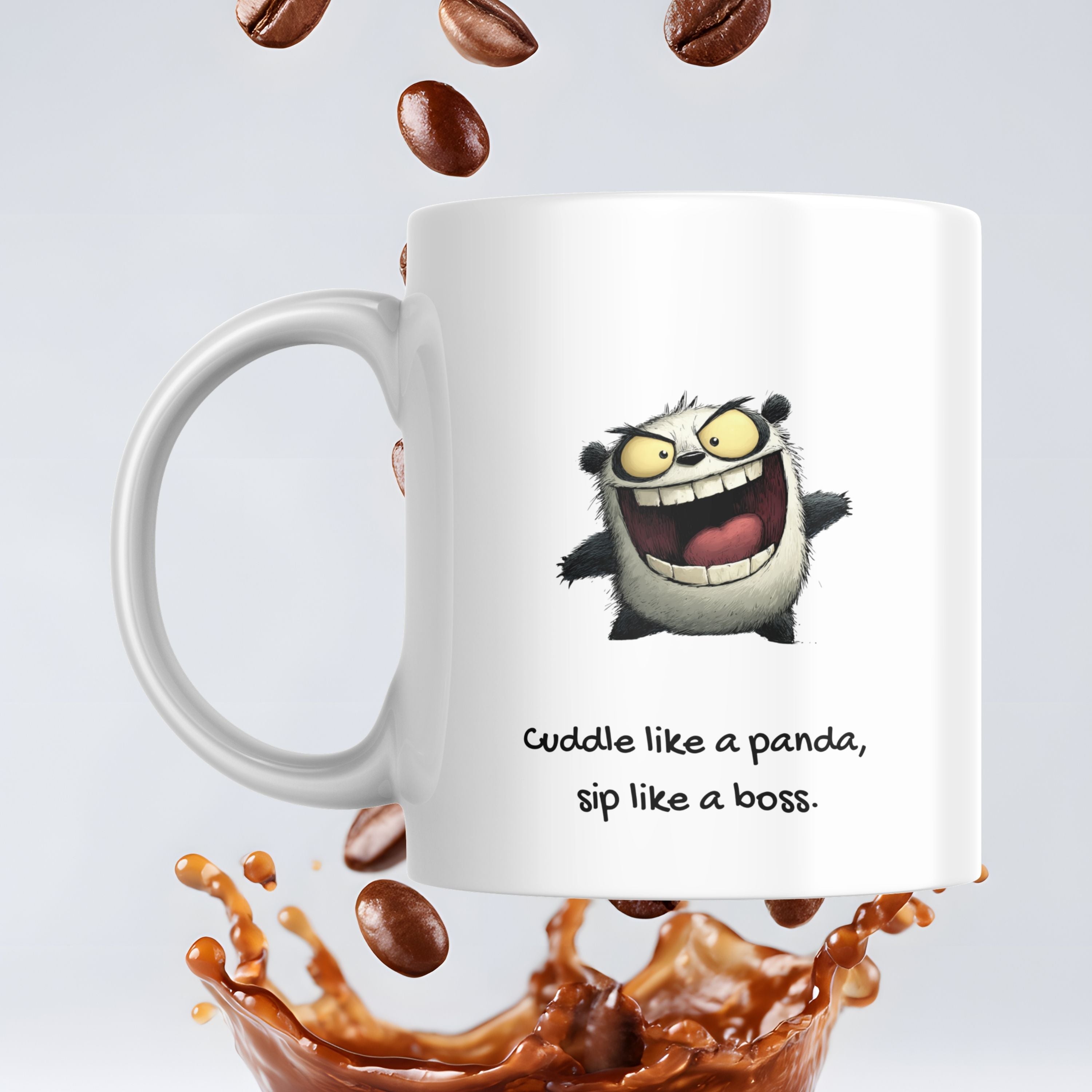 White mug with cartoon character and text 'Cuddle like a panda, sip like a boss.' surrounded by coffee beans and a coffee splash.