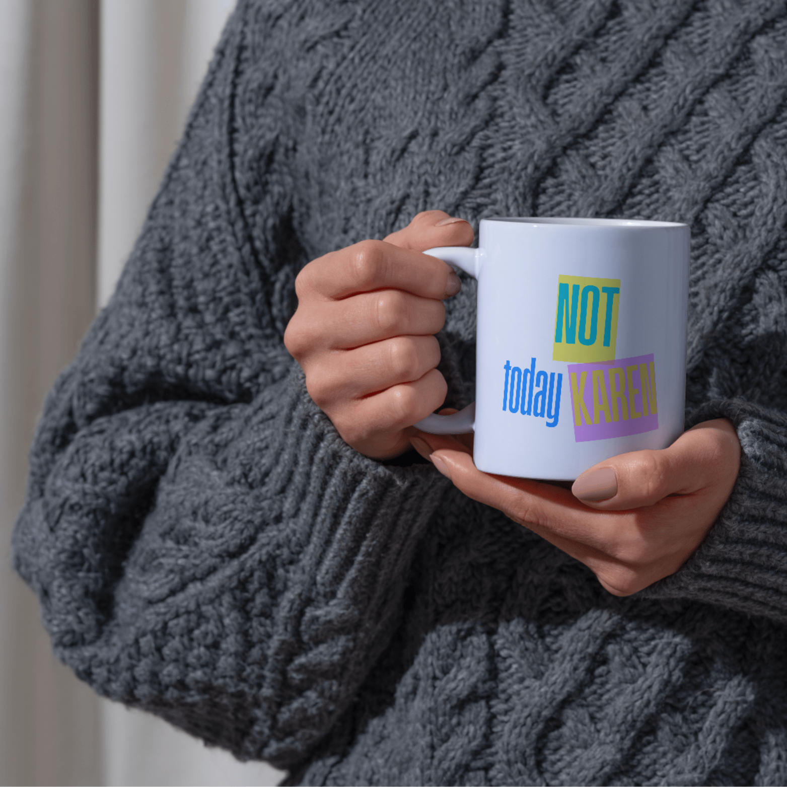 Person holding a mug with 'Not today Kаren' text in a cozy setting