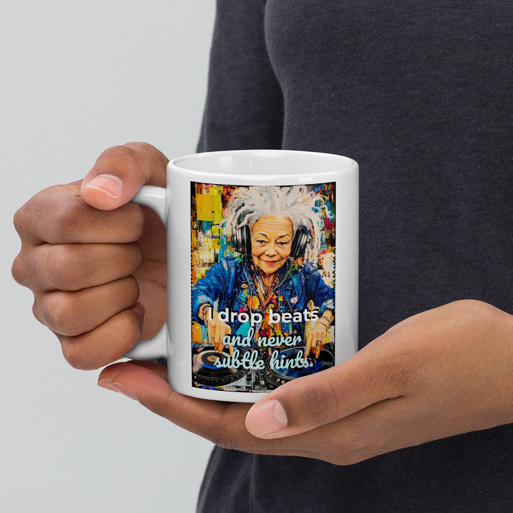 Person holding a mug with a colorful design of an elderly woman wearing headphones and text on a white background.