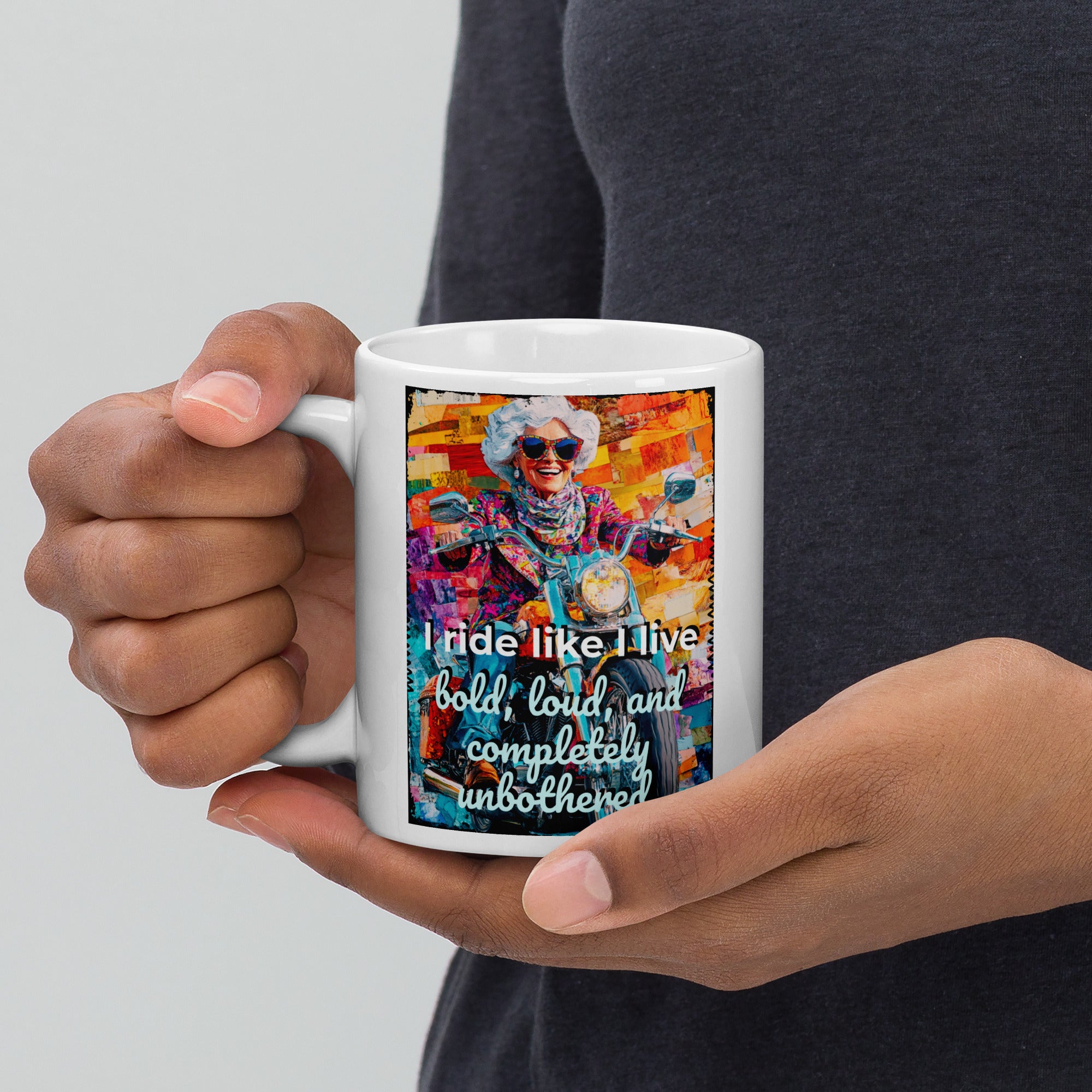 Person holding a mug with a colorful design and text on a plain background