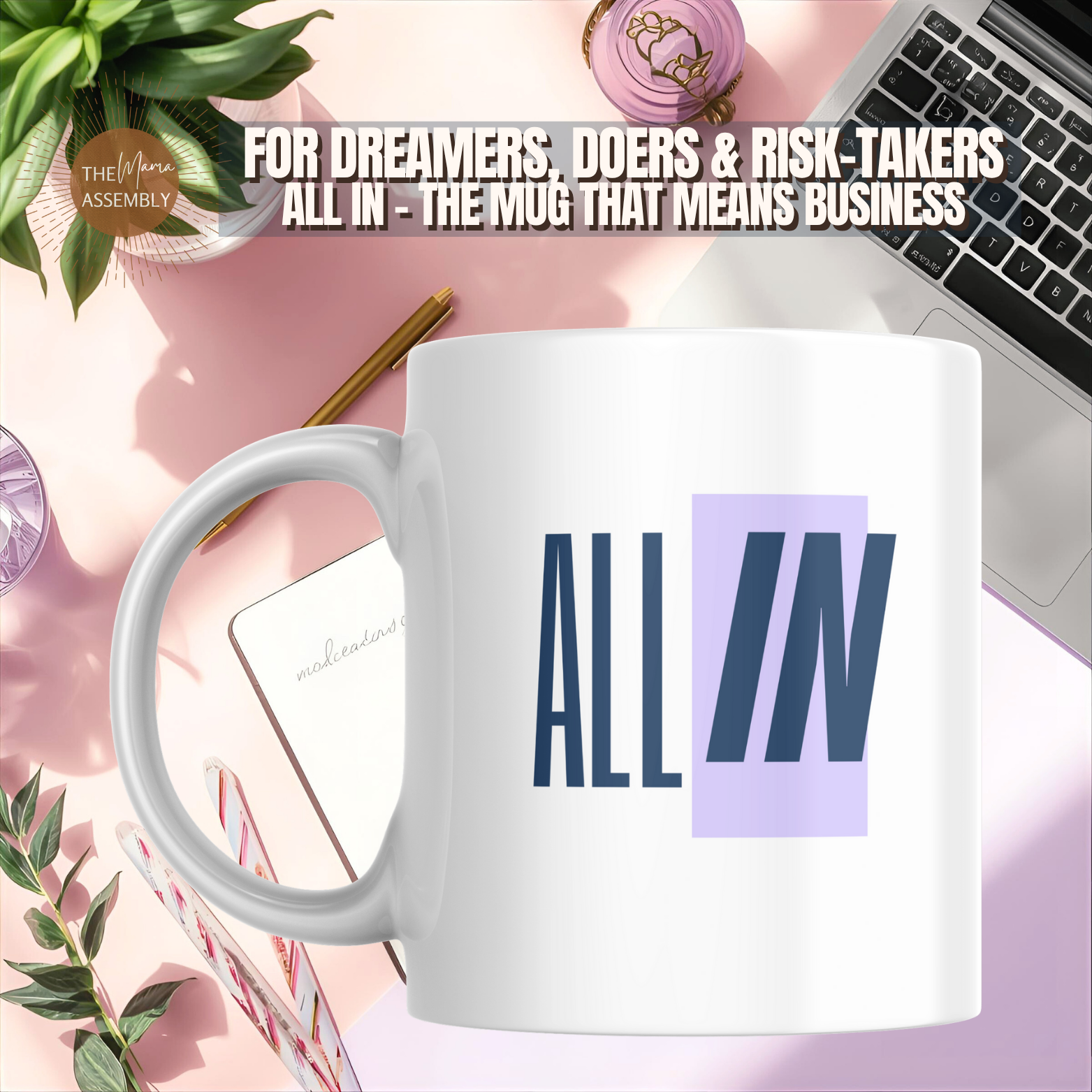 White mug with 'ALL IN' text on a desk with laptop, notebook, and plant