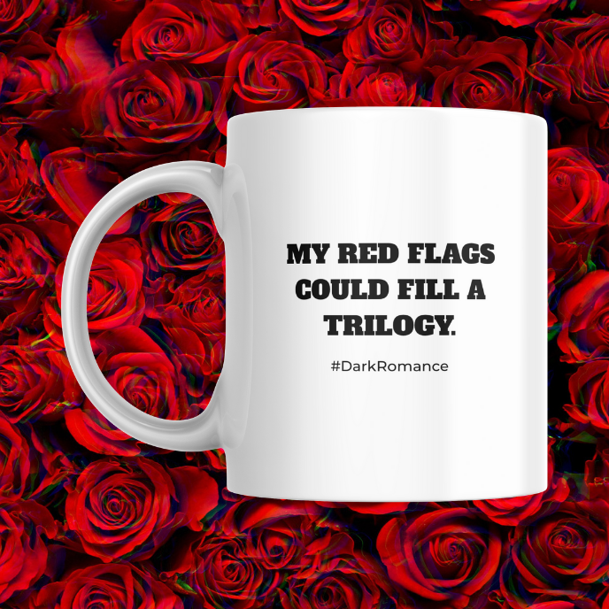 White mug with text 'My red flags could fill a trilogy. #DarkRomance' on a background of red roses.