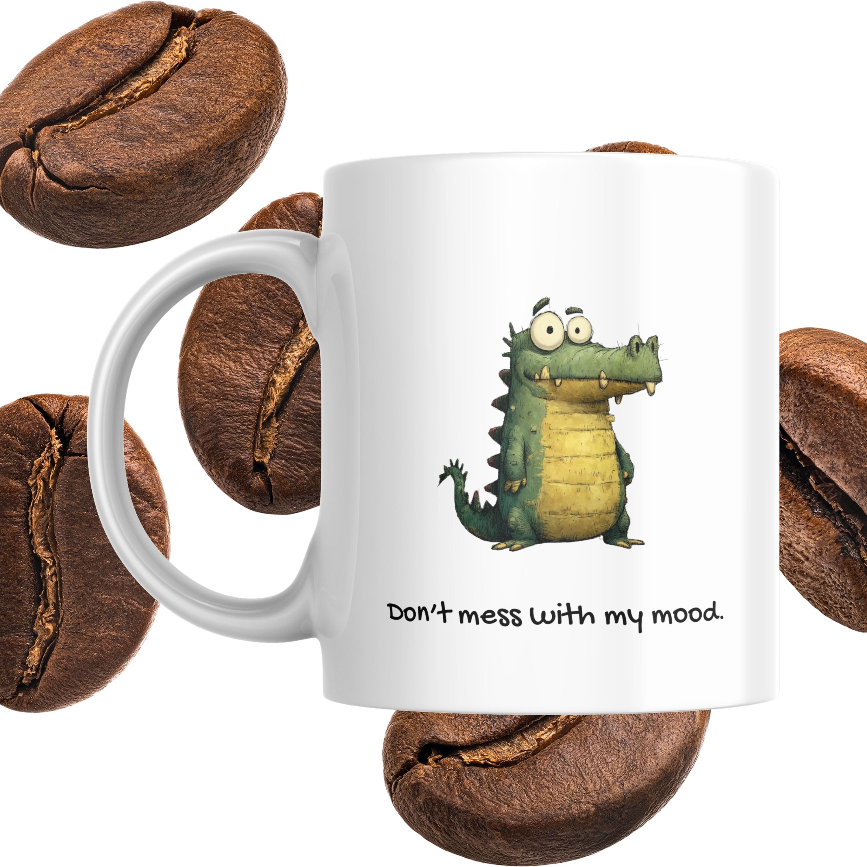 White mug with a cartoon dragon and text 'Don't mess with my mood' surrounded by coffee beans.