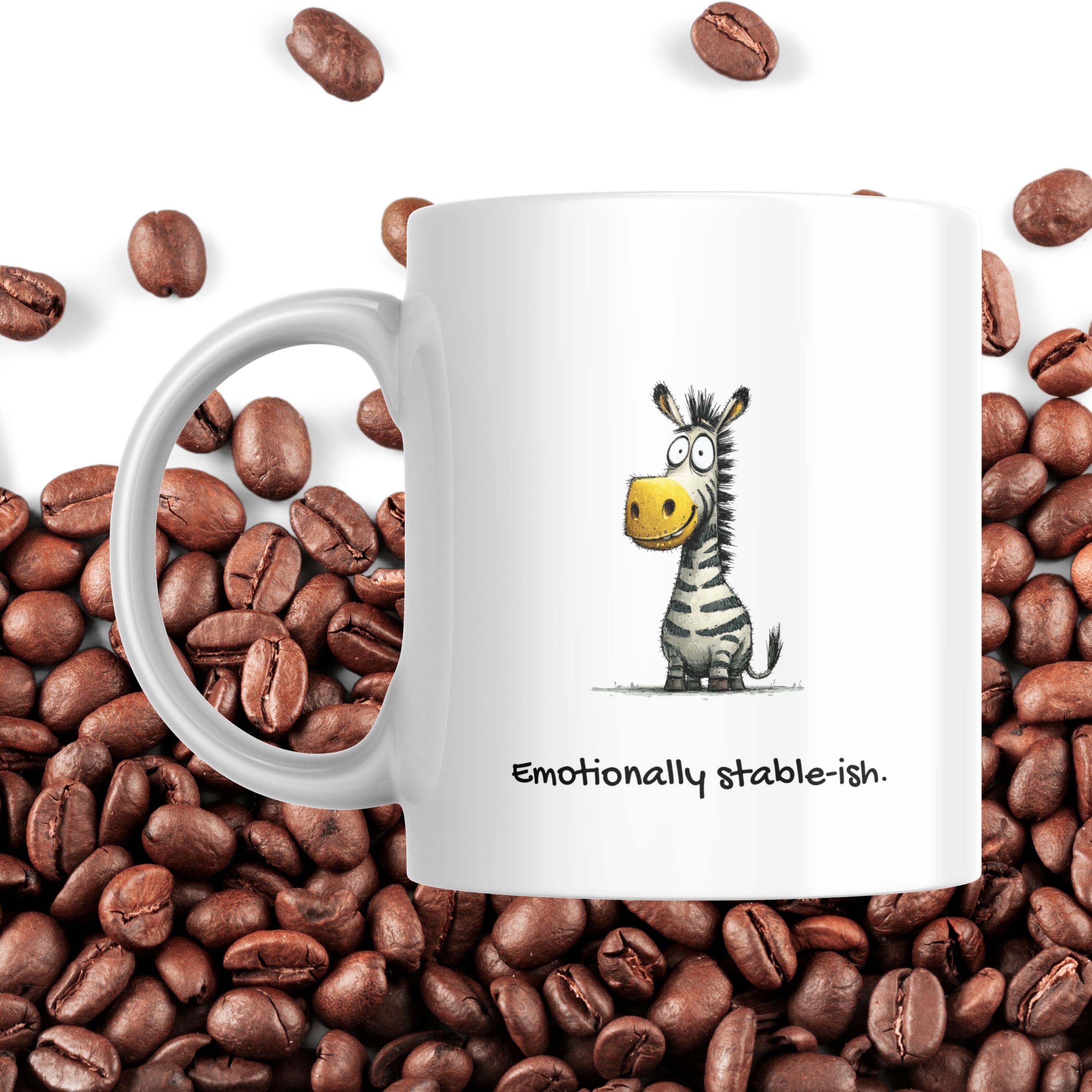White mug with a zebra illustration and text 'Emotionally stable-ish' on coffee beans.