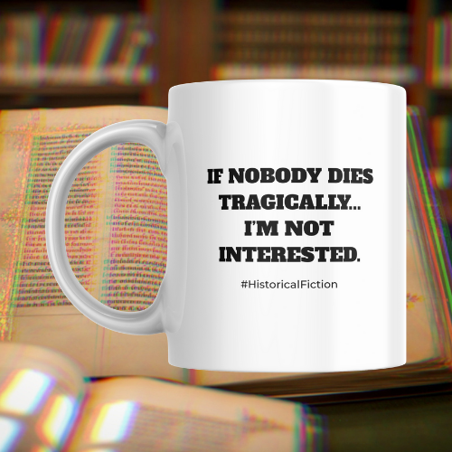 White mug with black text on a book background