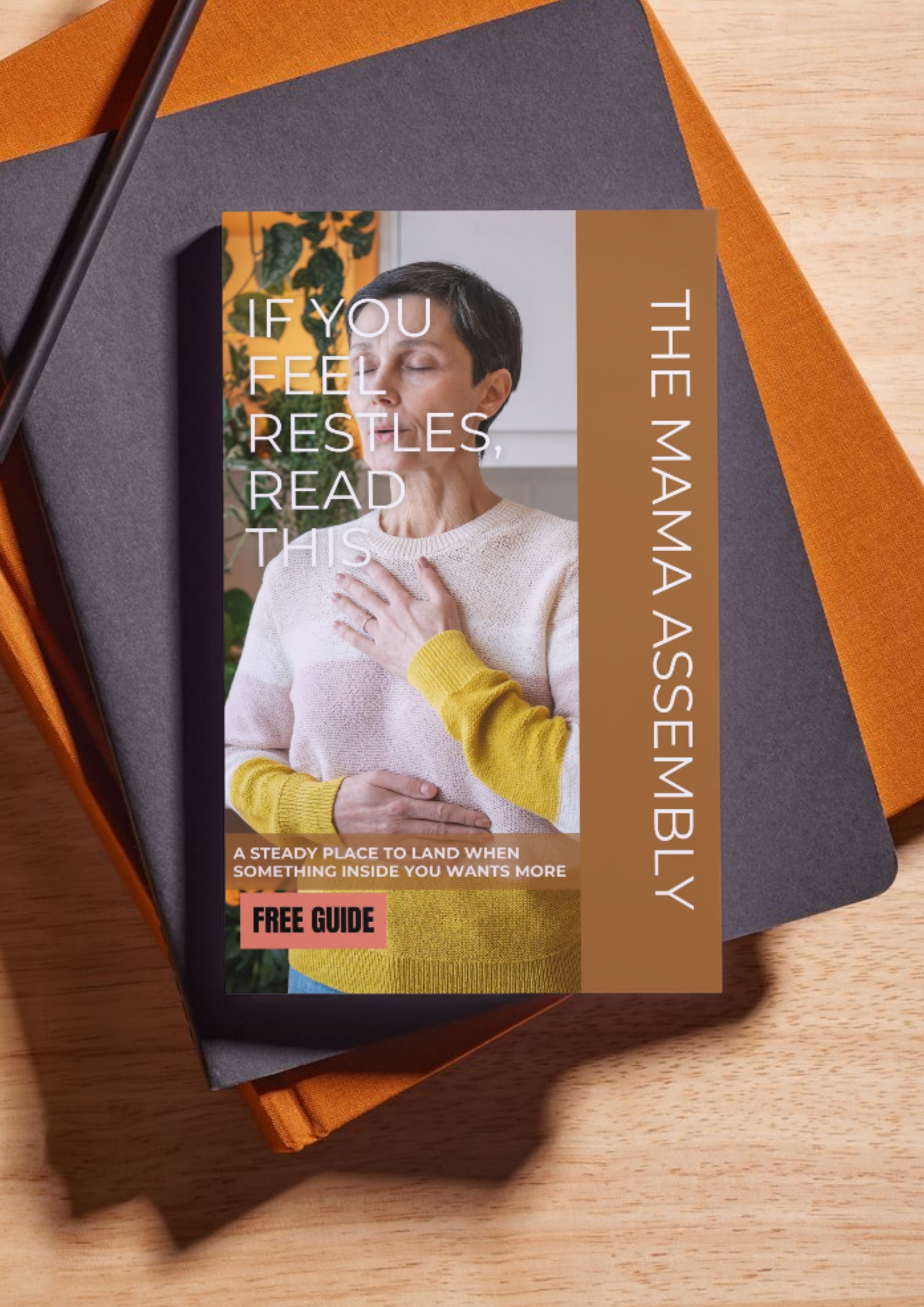 Book or guide titled 'The Mama Assembly' on a wooden surface