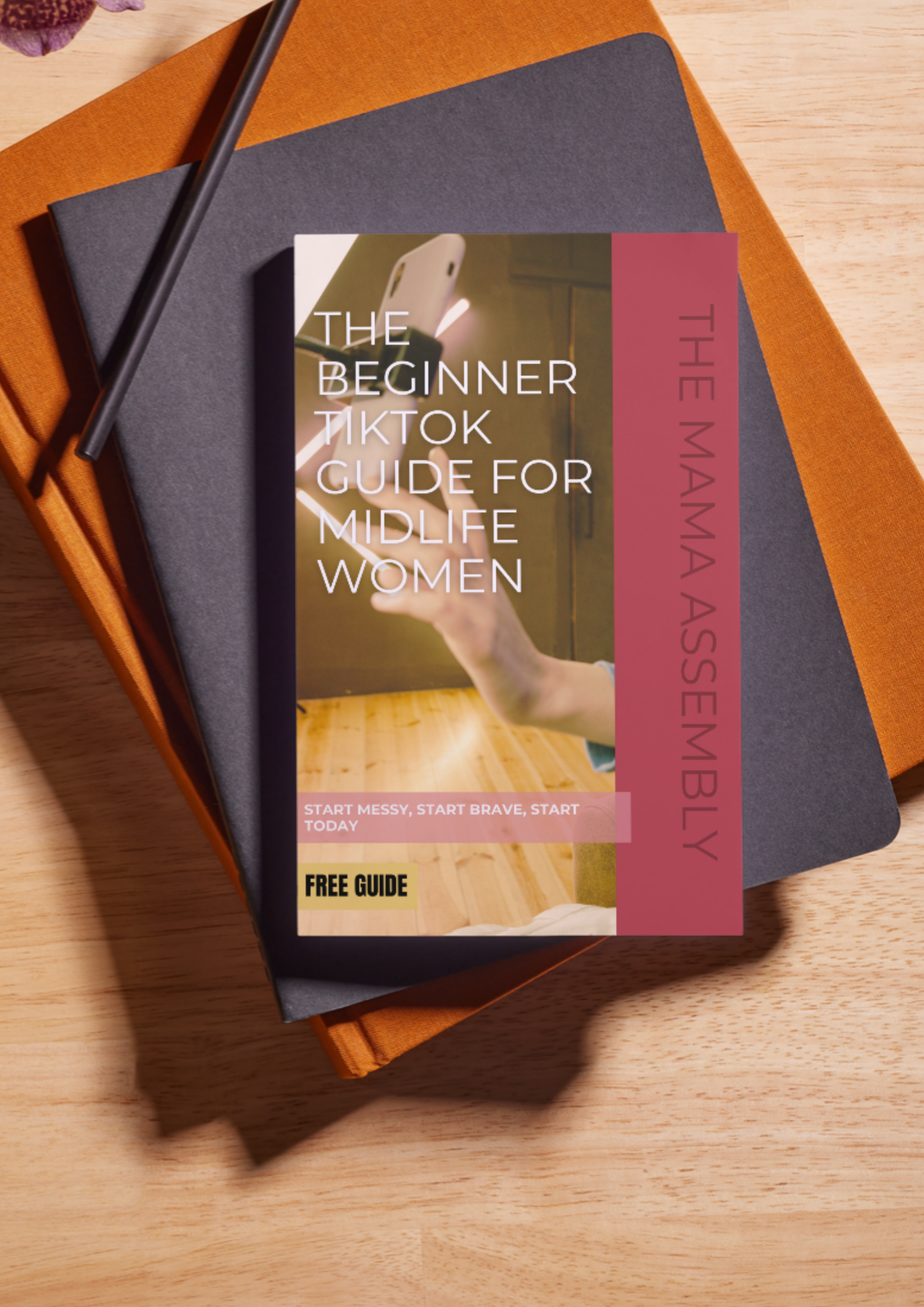 Book titled 'The Beginner TikTok Guide for Midlife Women' by The Mama Assembly on a wooden surface.