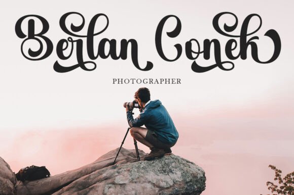 Person taking a photograph on a rock with 'Bertan Conek Photographer' text overlay