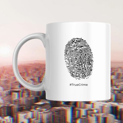 White mug with fingerprint design and '#TrueCrime' text against a cityscape background