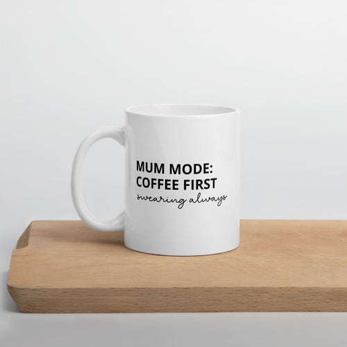 White ceramic mug with black text that reads "Mum mode: coffee first, swearing always" – cheeky mum mug.