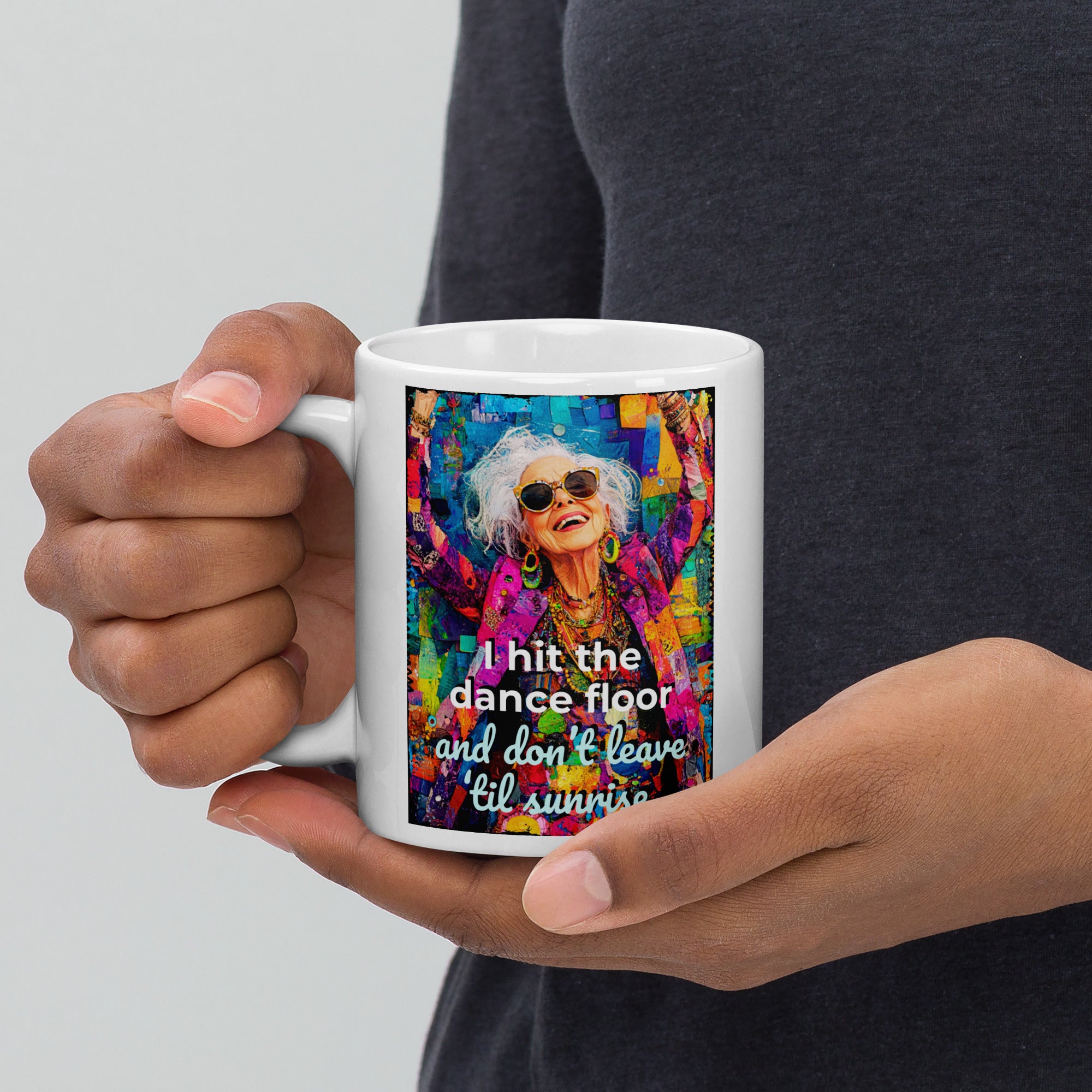Person holding a mug with a colorful design and text on a plain background