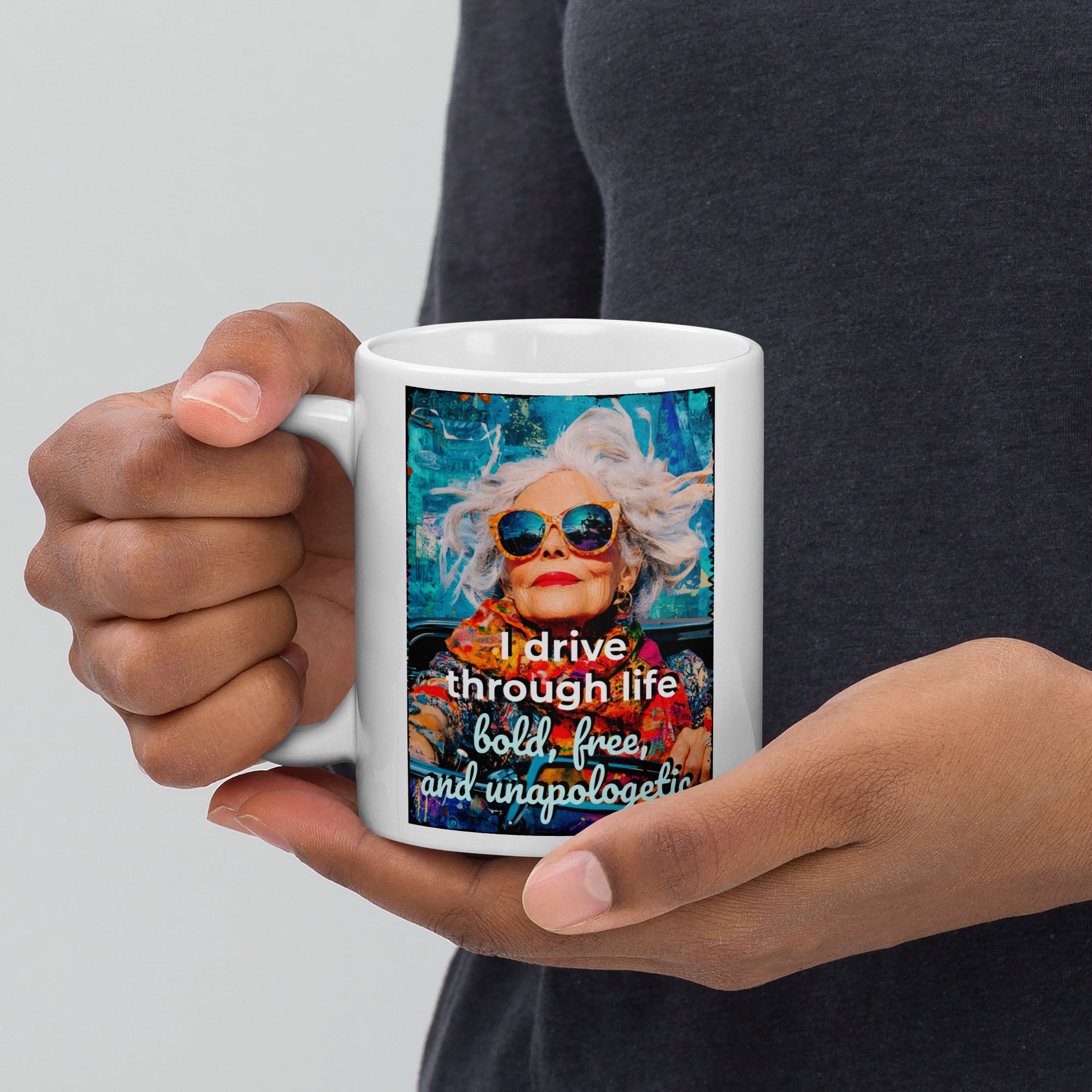 Person holding a mug with a colorful design and text on a plain background