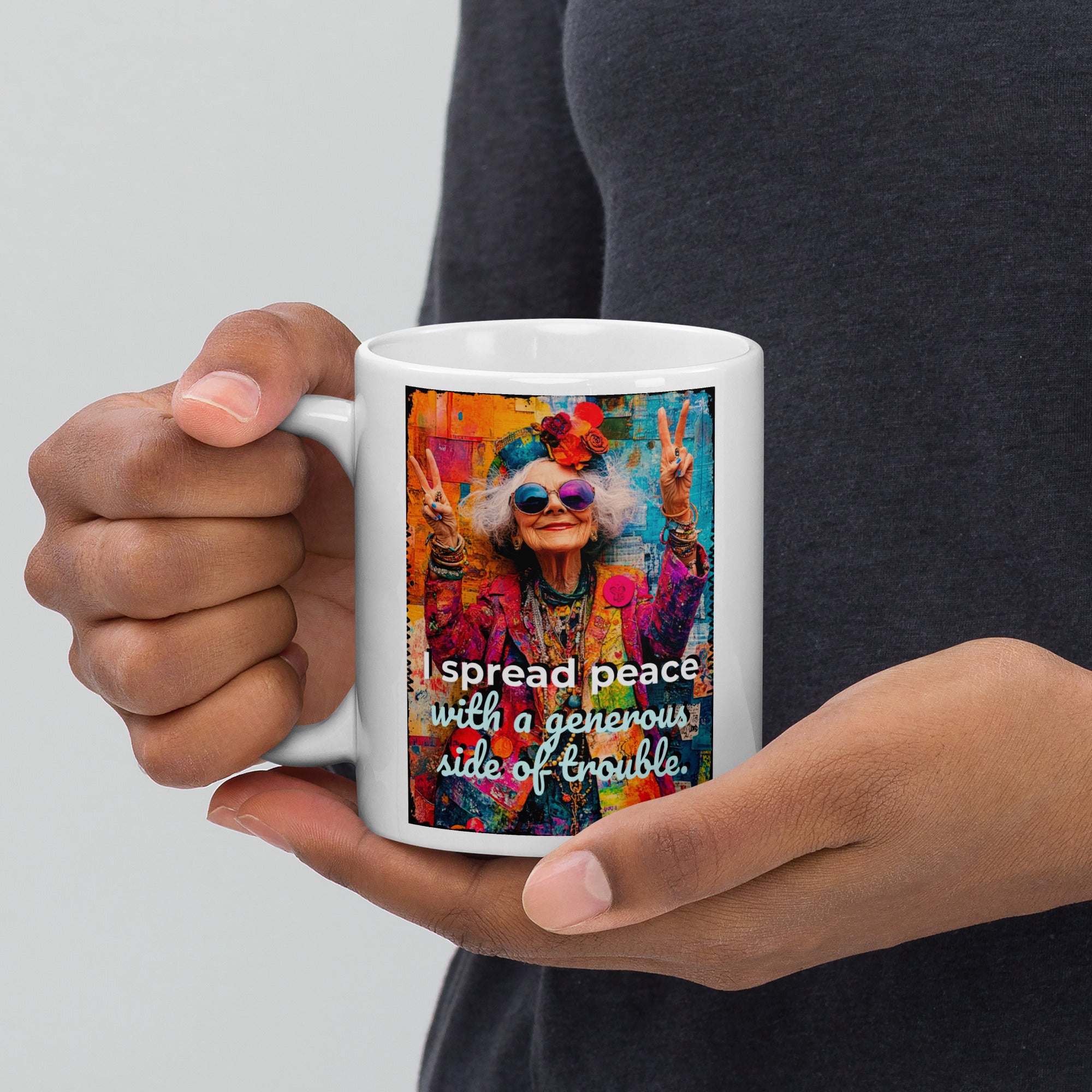 Person holding a mug with a colorful design and text on a plain background