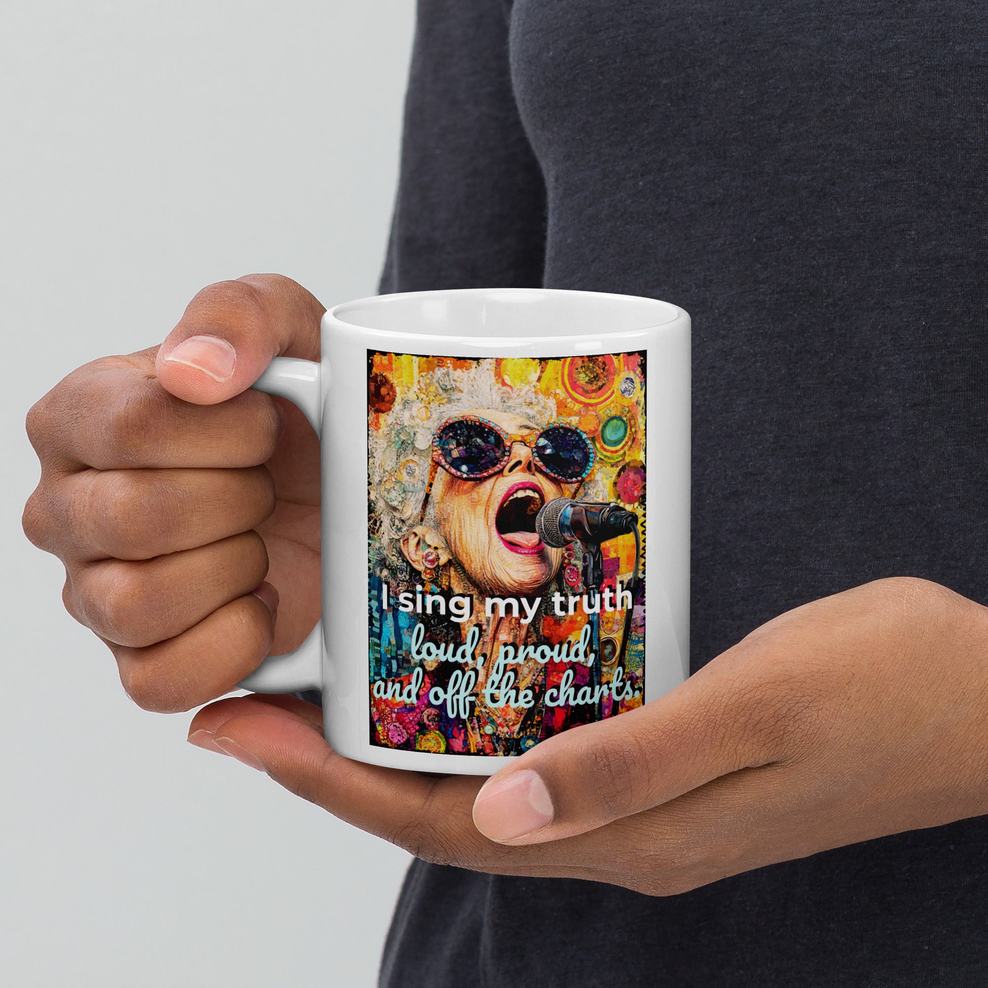 Person holding a mug with a colorful design and text on a plain background