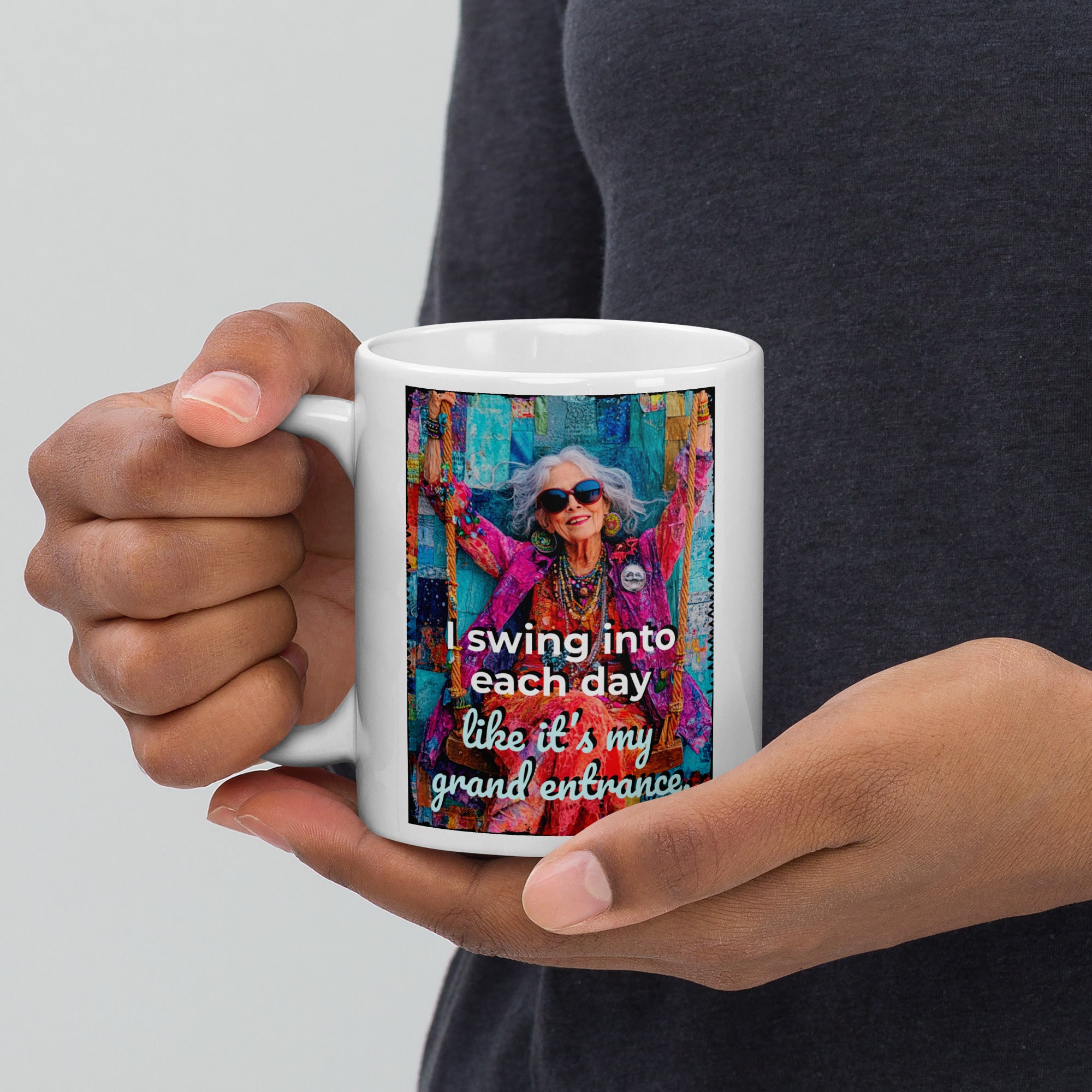 Person holding a mug with a colorful design and text on a plain background