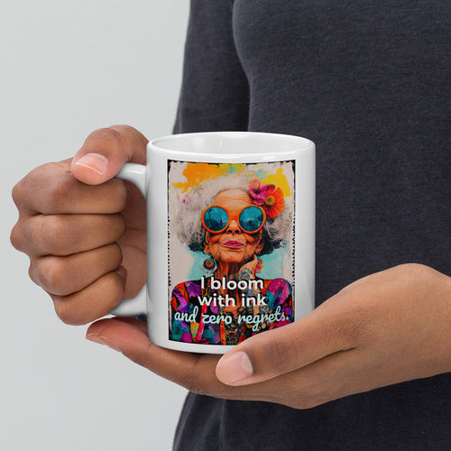 Person holding a mug with a colorful design and text on a plain background