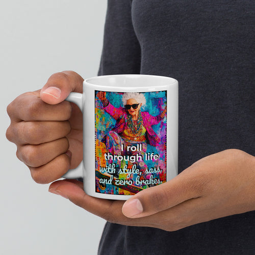 Person holding a mug with a colorful design and text on a plain background