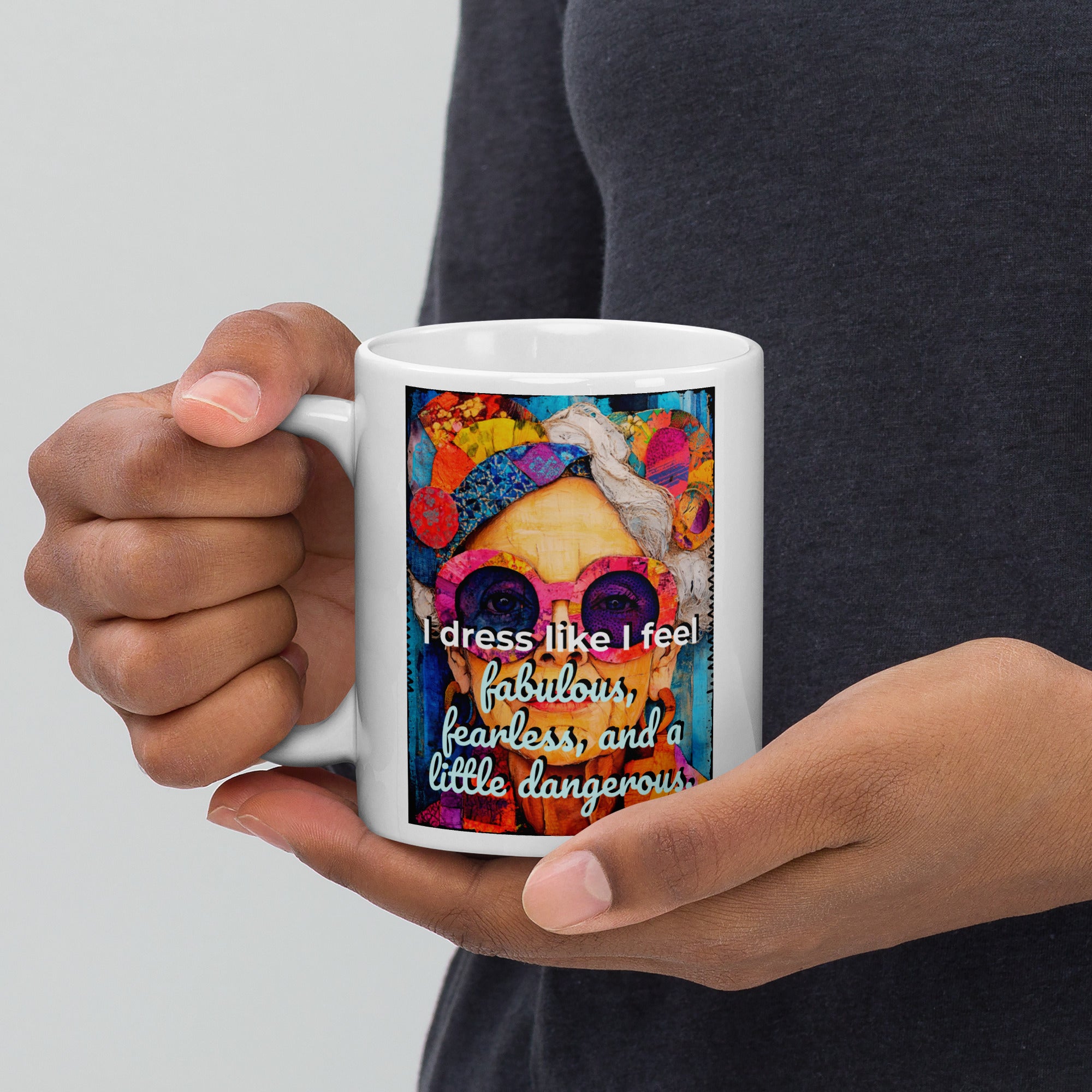 Person holding a mug with a colorful design and text.
