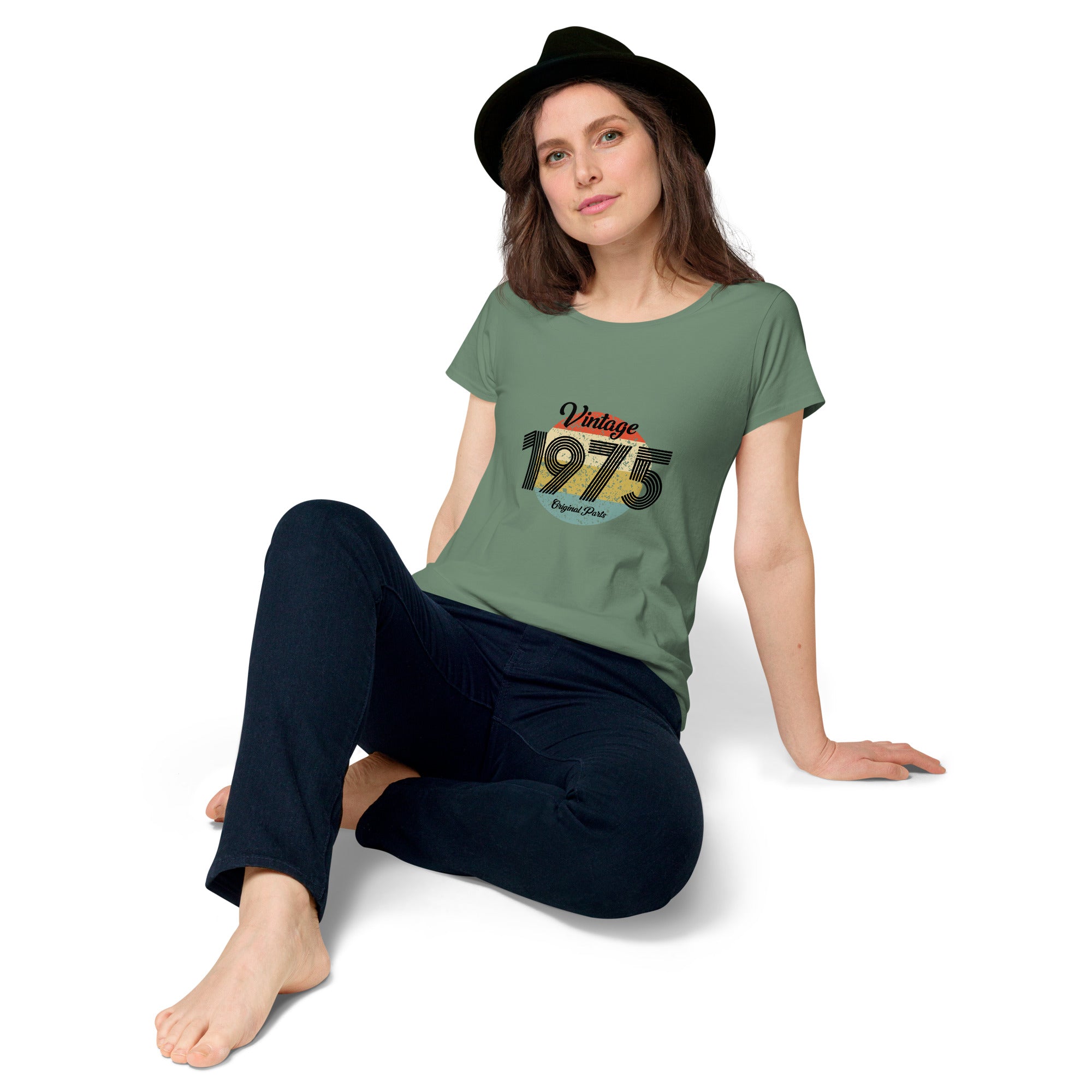 A woman wearing a green women's t-shirt with 'Vintage 1975' printed on the front.