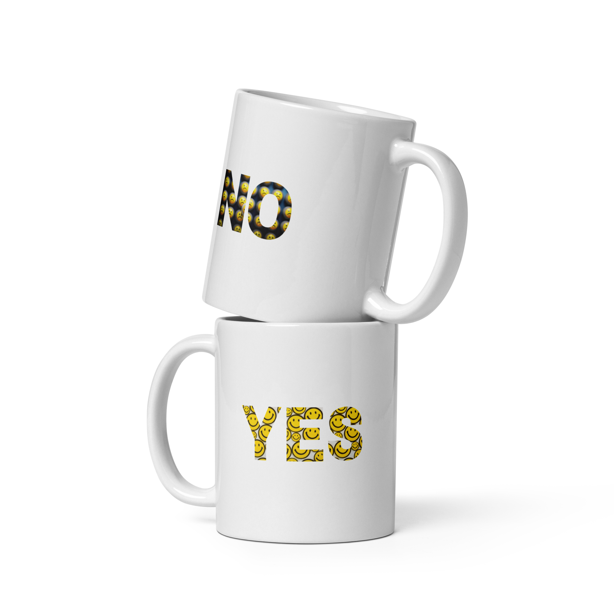 Two white mugs with 'NO' and 'YES' printed on them in gold letters against a white background.