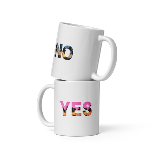 Two white mugs stacked on top of each other with colorful text on a white background