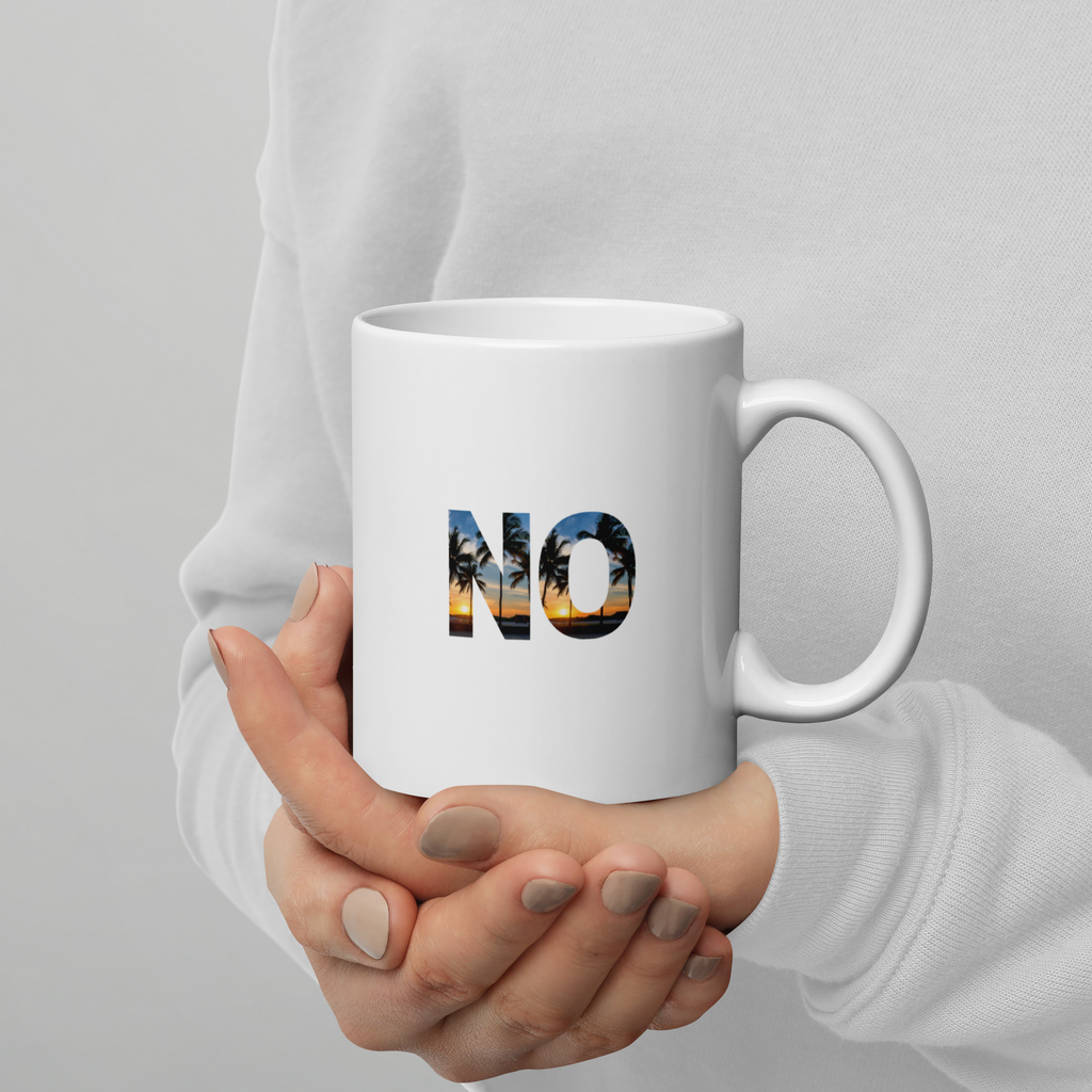 Hand holding a white mug with 'NO' and palm tree design against a gray background